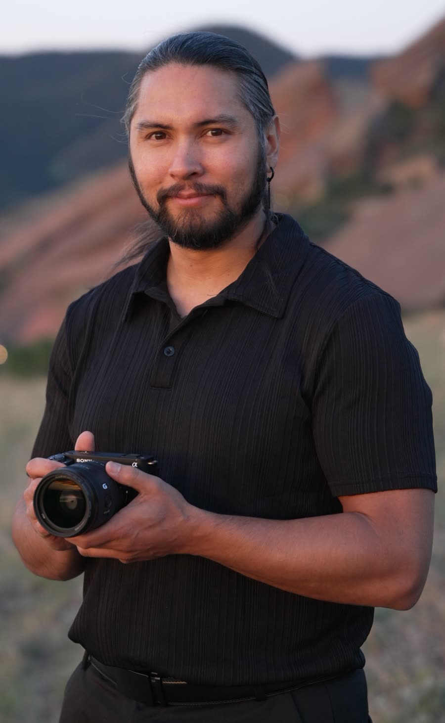 Lobo, cinematographer, holding his camera in the Colorado foothills